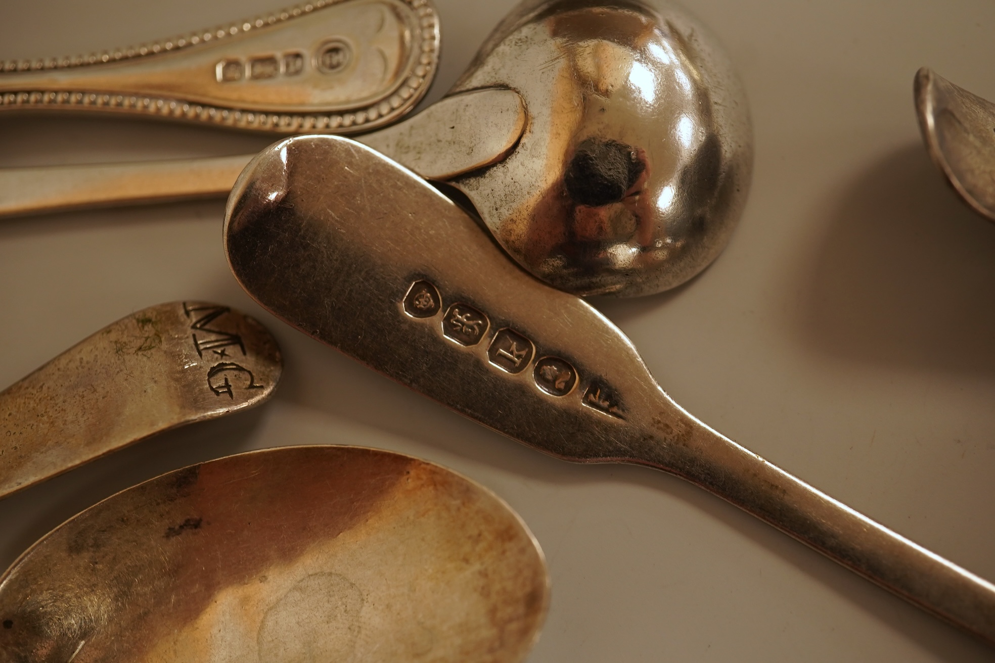 A small quantity of 18th century and later assorted silver teaspoons, various patterns, dates and makers, together with a George V silver pastry fork and two George V silver caddy spoons, 10.7oz.